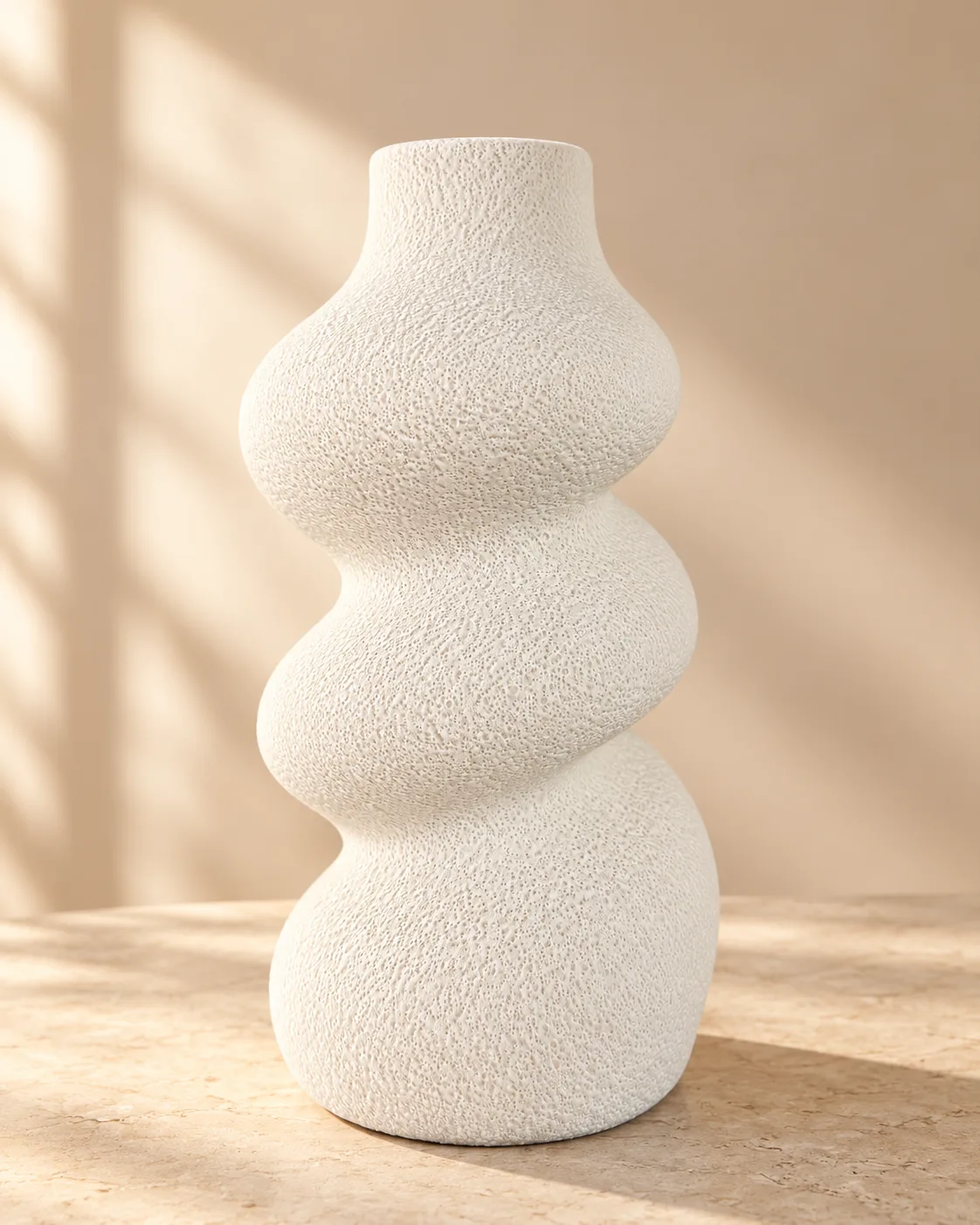 White decorative vase with a swirled design and embossed pattern